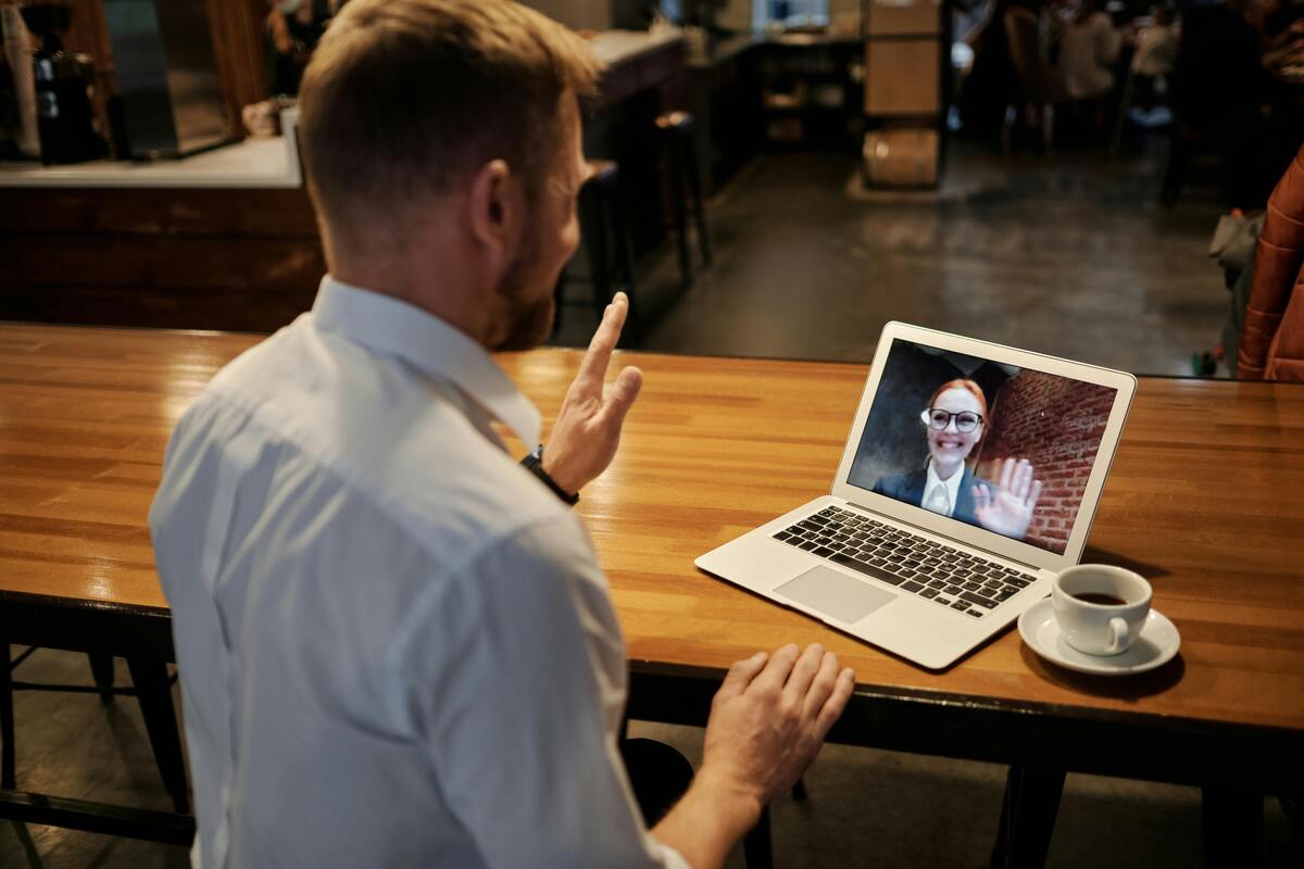 a man talking to a woman on a laptop