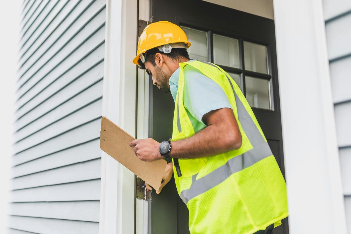 a man wearing a yellow hard hat and safety vest